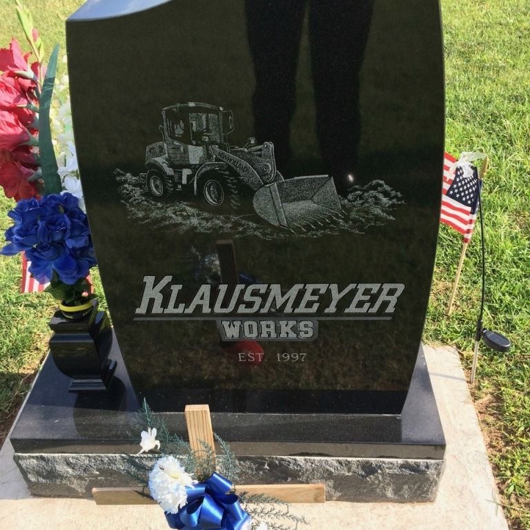 A black gravestone with the name klausmeyer on it