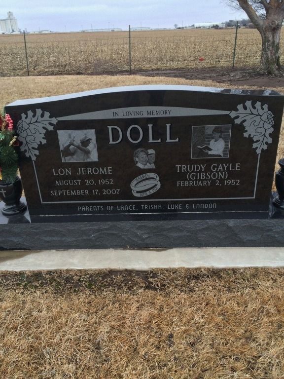 A black gravestone with the name doll on it