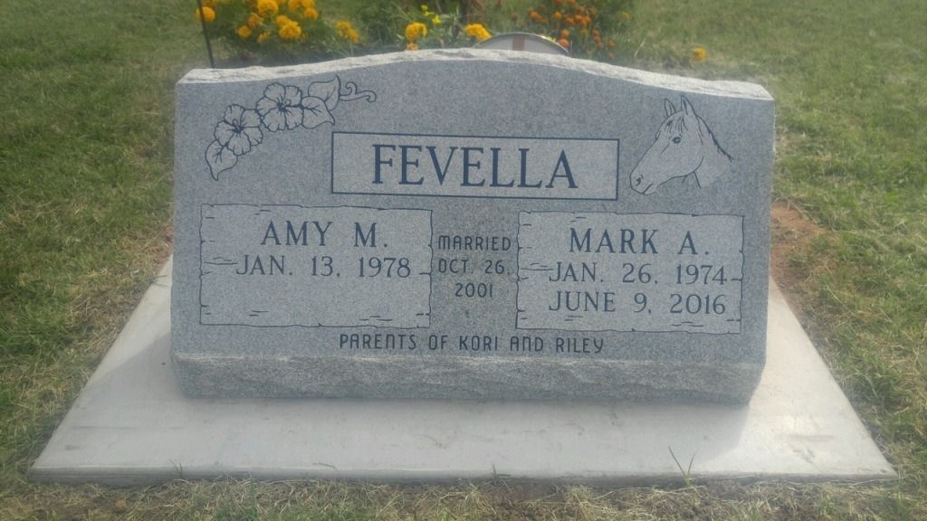 A gravestone for amy m. and mark a. in a cemetery.