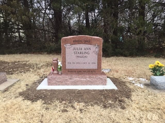 A gravestone for julia ann starling in a cemetery.