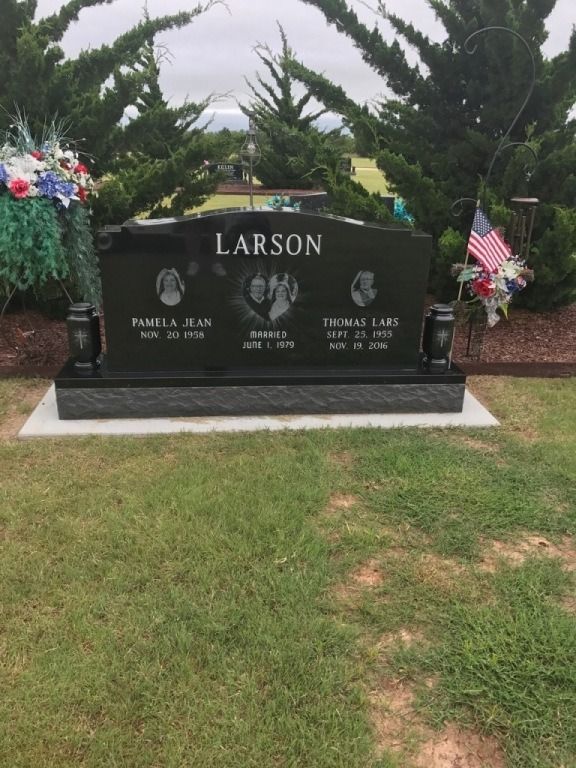 A black gravestone with the name larson on it