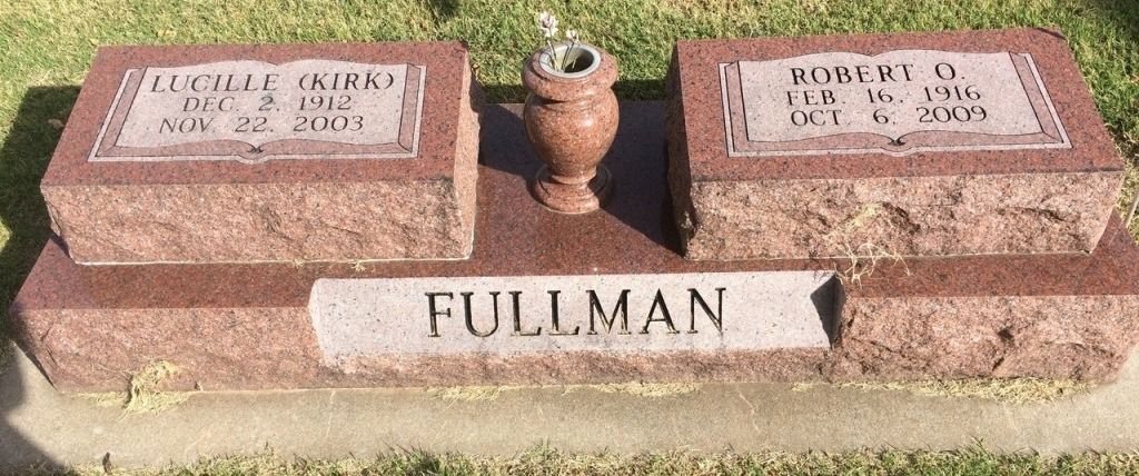A graveyard with two graves and a vase in the middle.