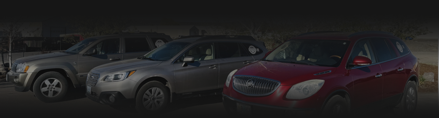 Three cars, including a red SUV, are parked outdoors. | Kings Auto LLC