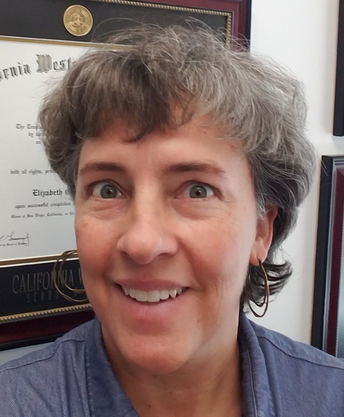 A woman wearing a lanyard with the year 2012 on it A woman wearing a lanyard with the year 2012 on it