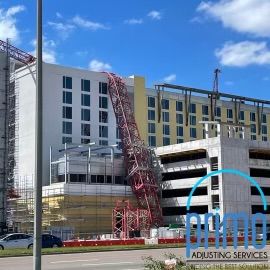 A building under construction with a sign that says adjusting services