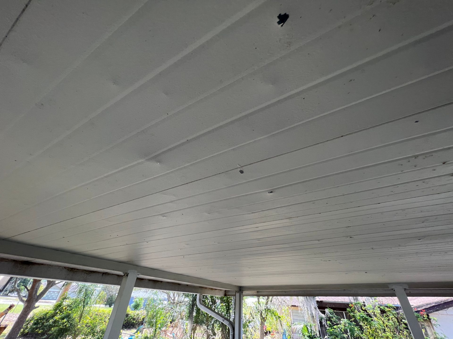 A close up of the ceiling of a wooden structure.