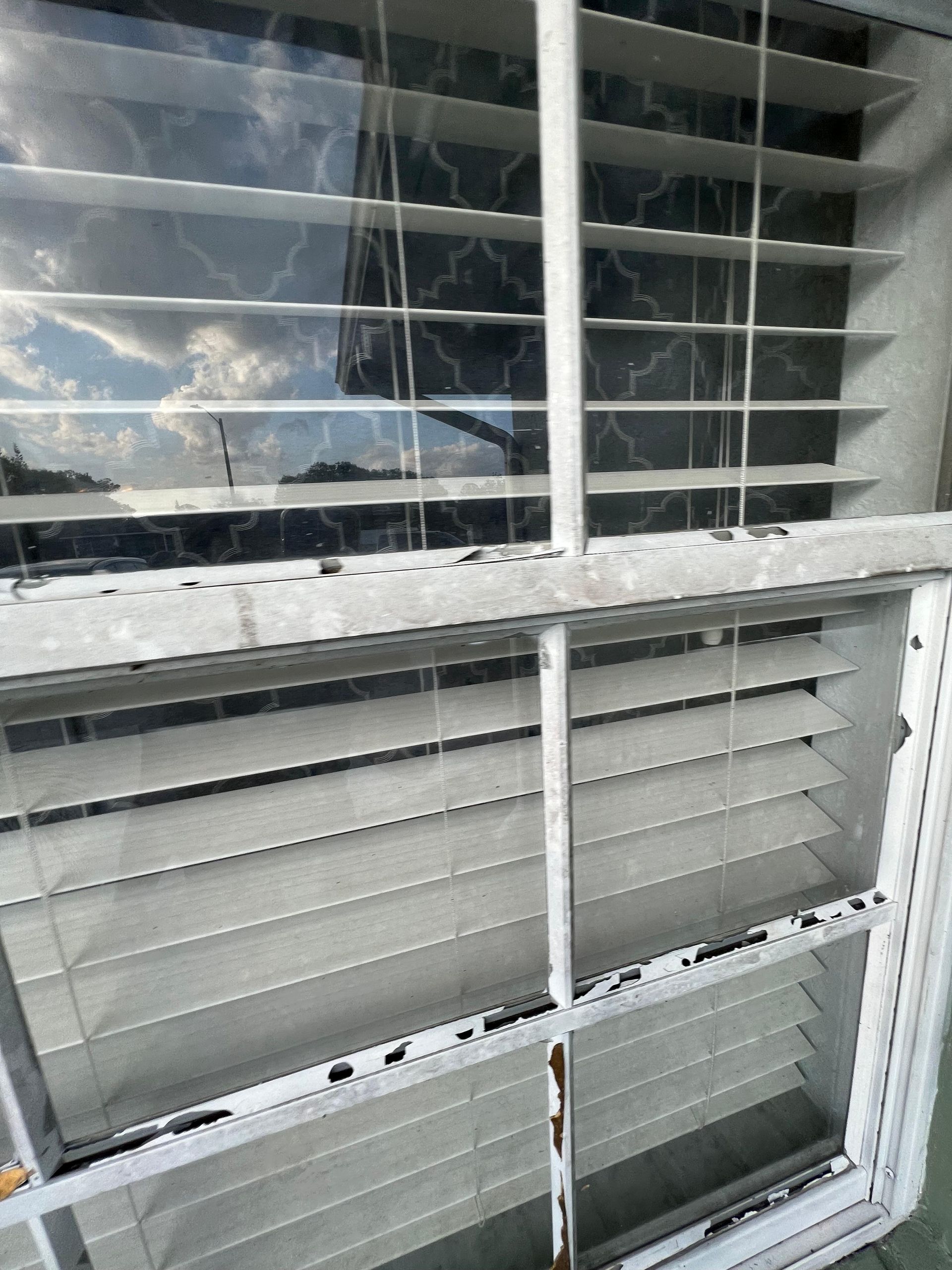 A close up of a window with blinds on it.