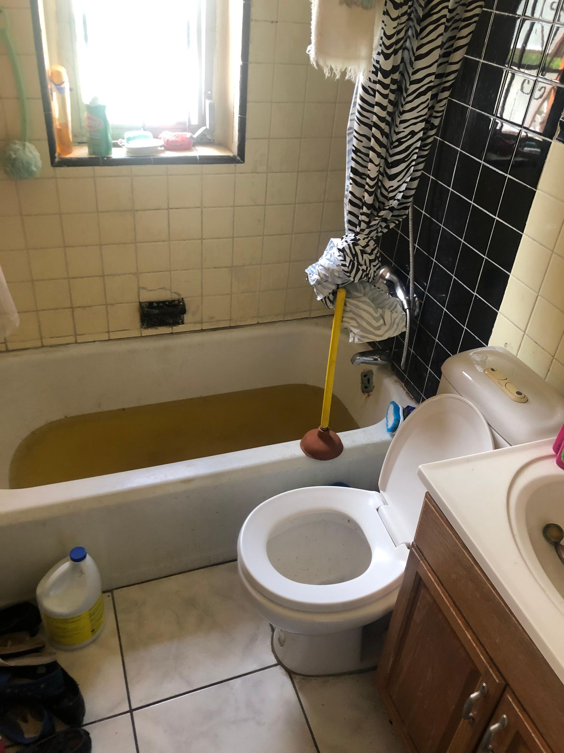 A bathroom with a toilet a sink and a bathtub