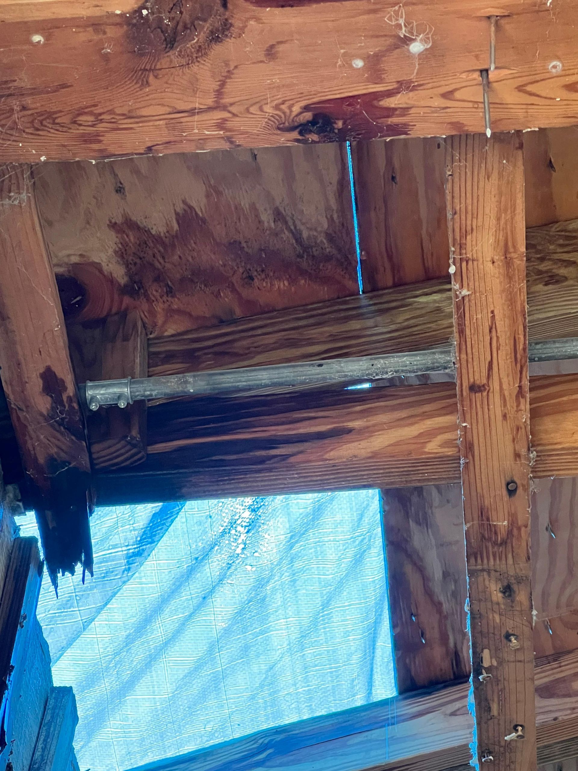 A close up of a wooden structure with water coming out of it.