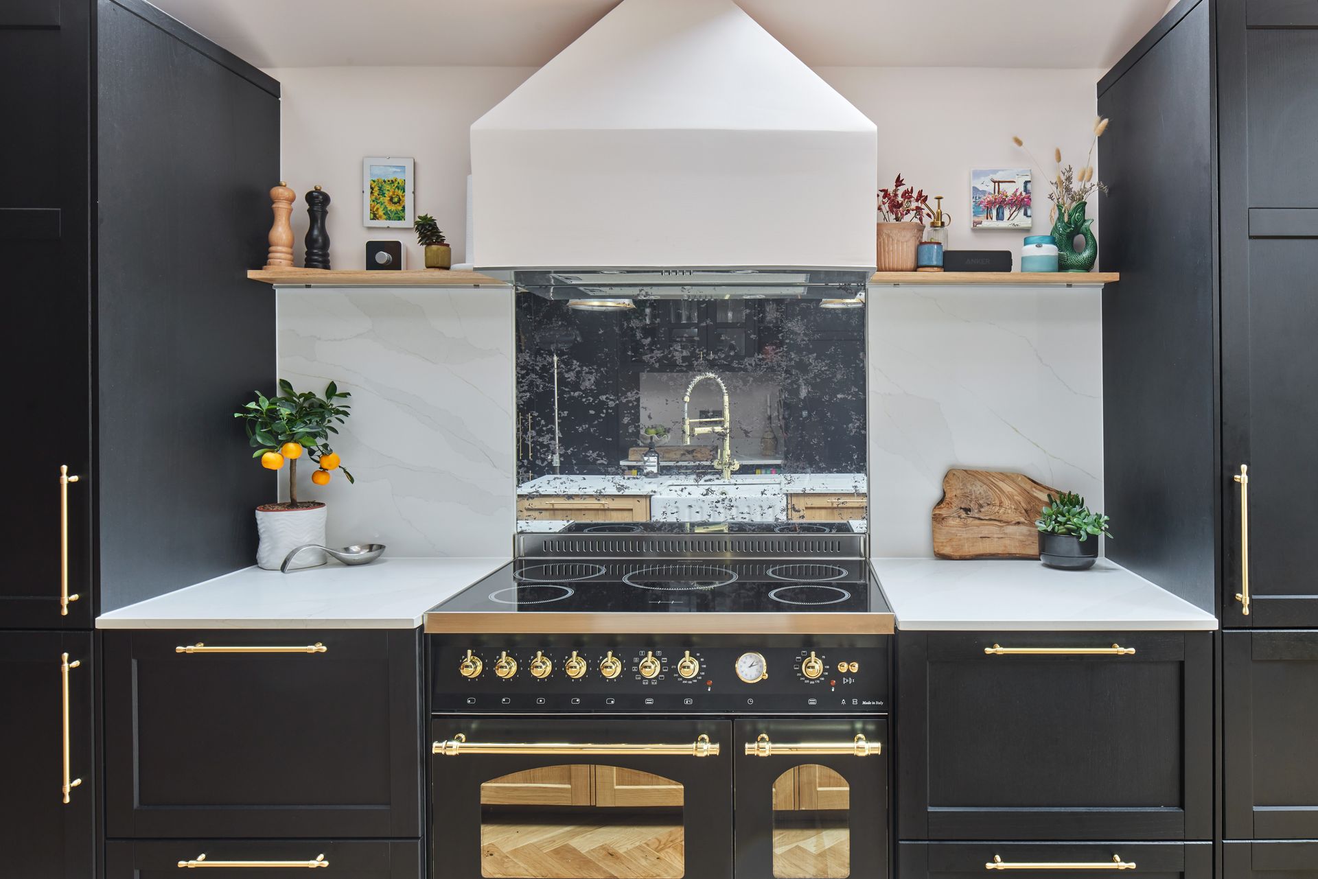 A kitchen with black cabinets and a stove top oven