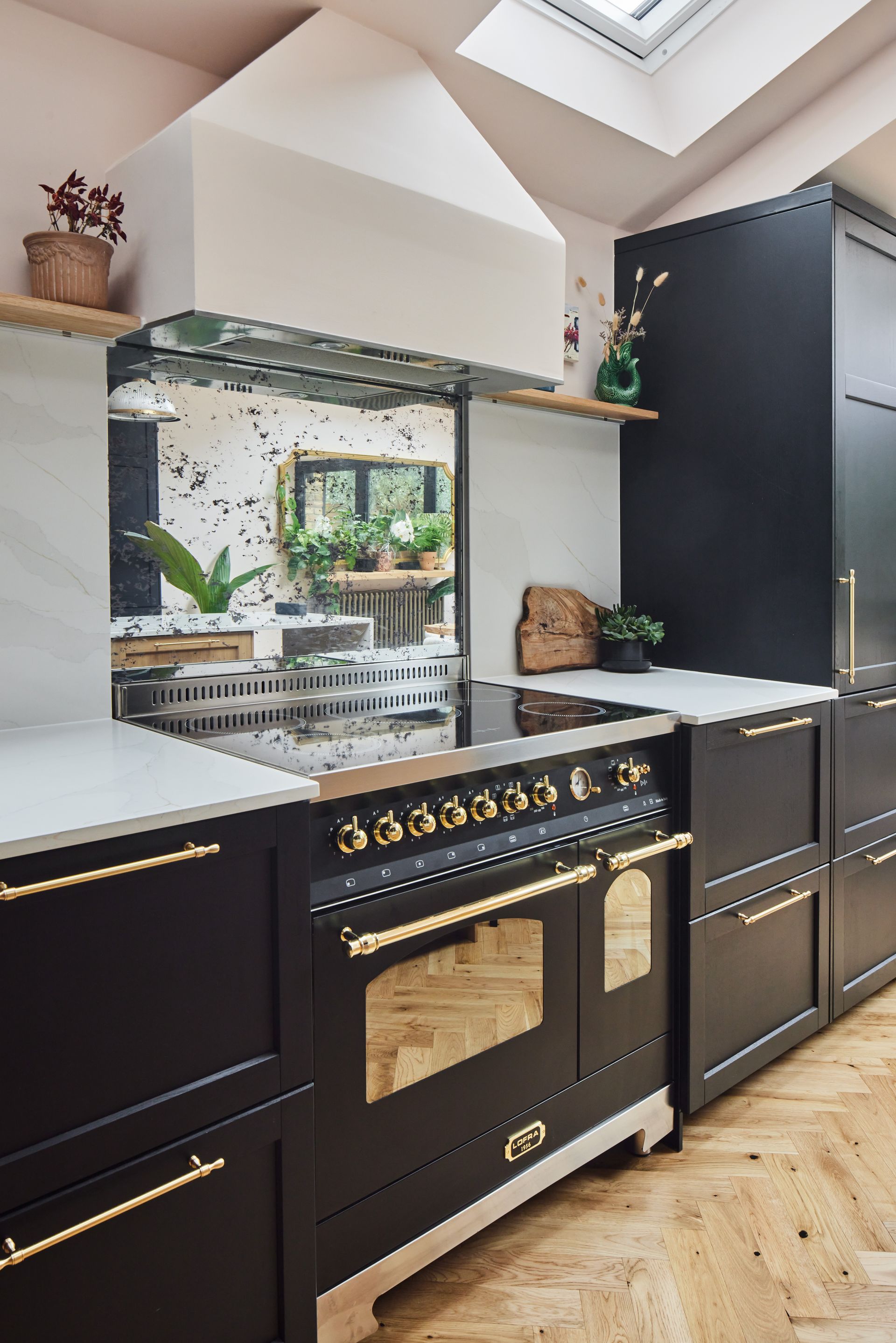 A kitchen with black cabinets and a black stove top oven.