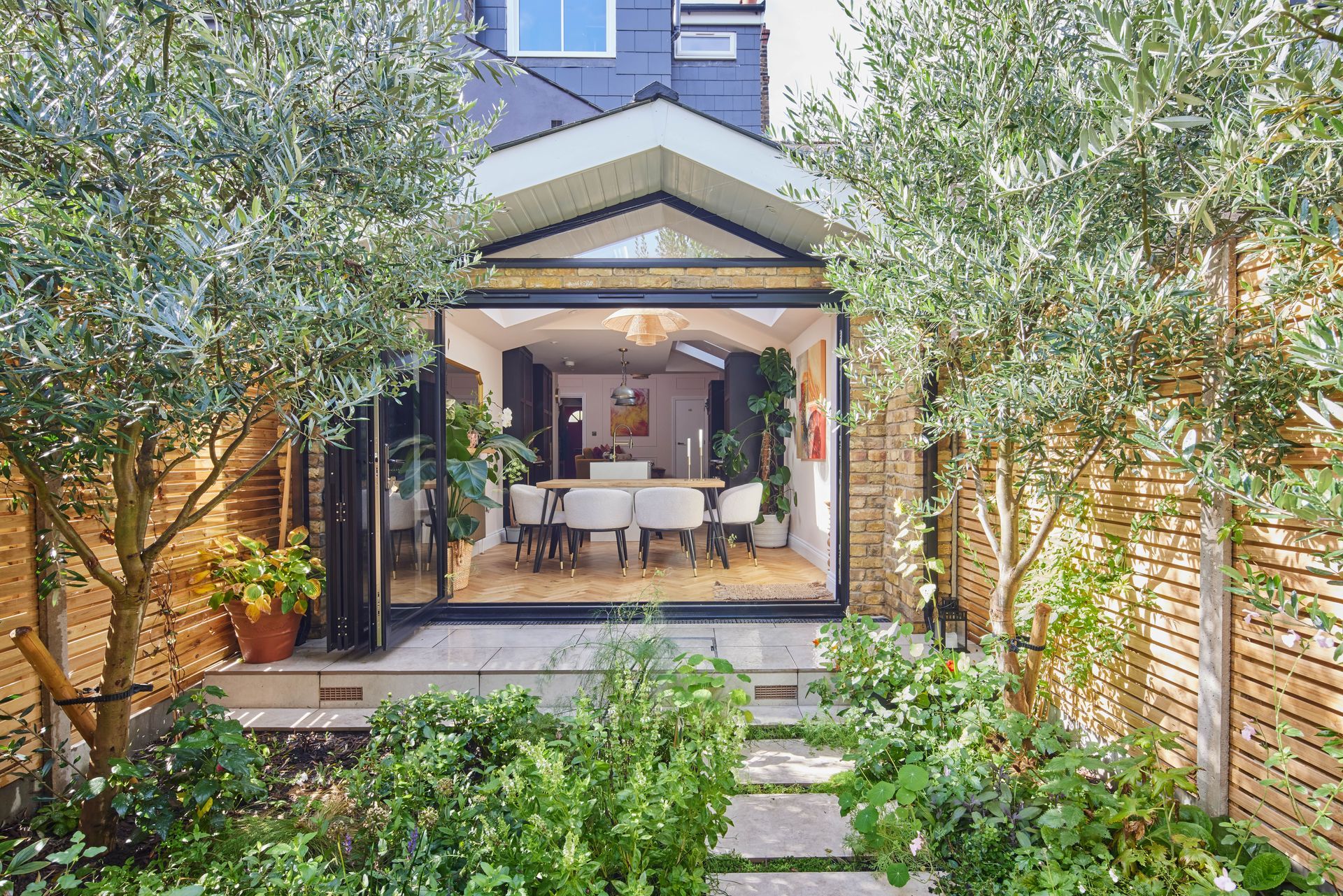 The back of a house with a large sliding glass door leading to a dining room.