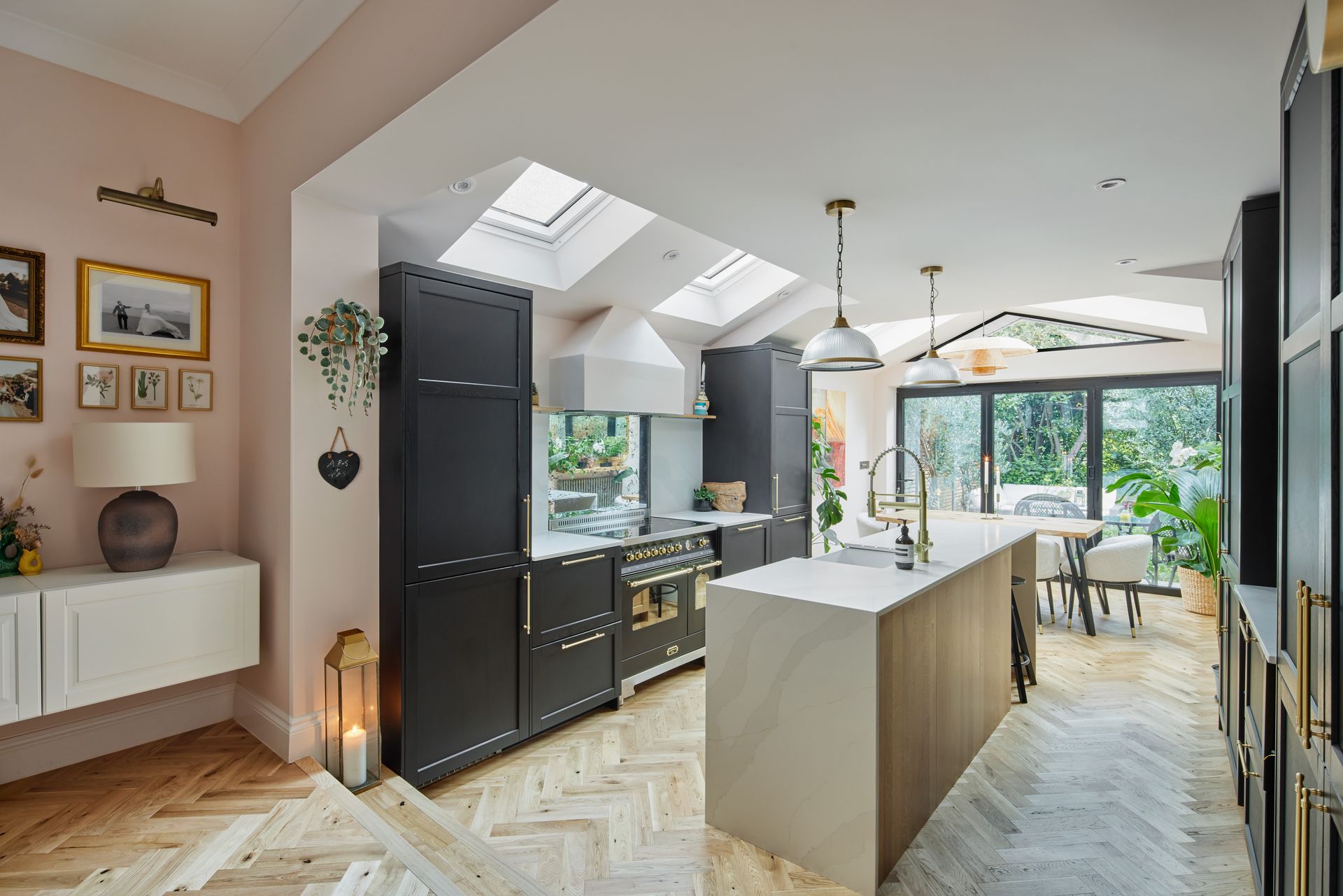 A kitchen with black cabinets and a large island in the middle of the room.