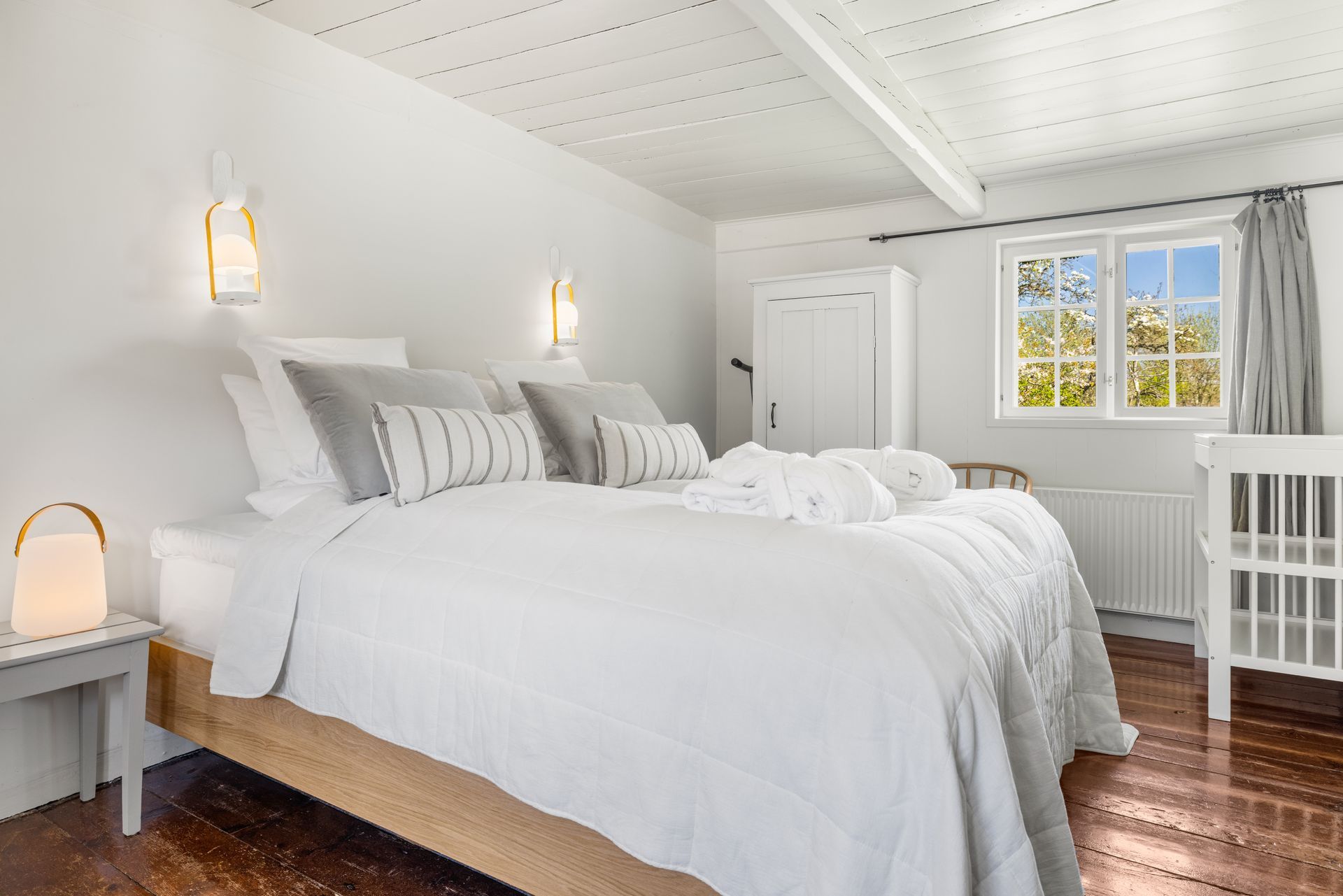 A bedroom with a large bed and a window.
