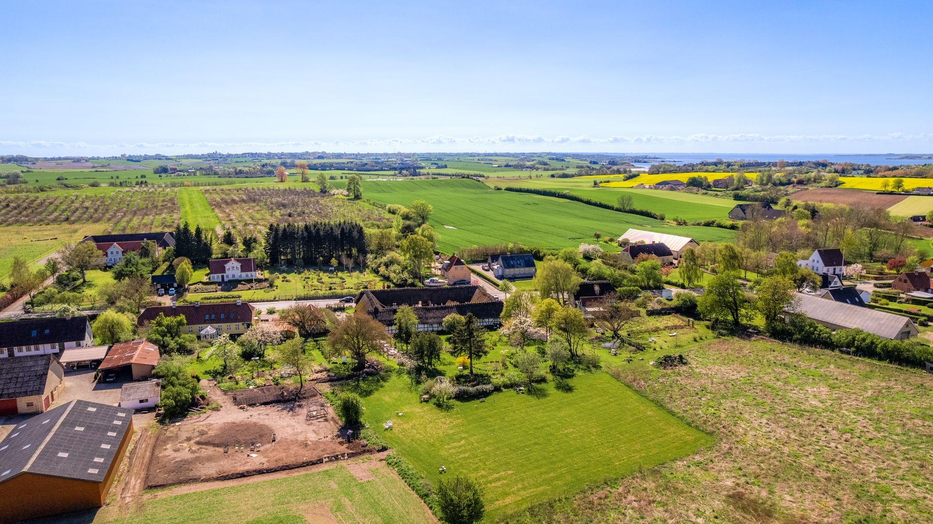 An aerial view of a farm with lots of fields and houses.