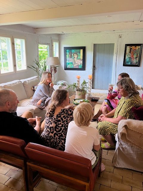 A group of people are sitting in a living room.