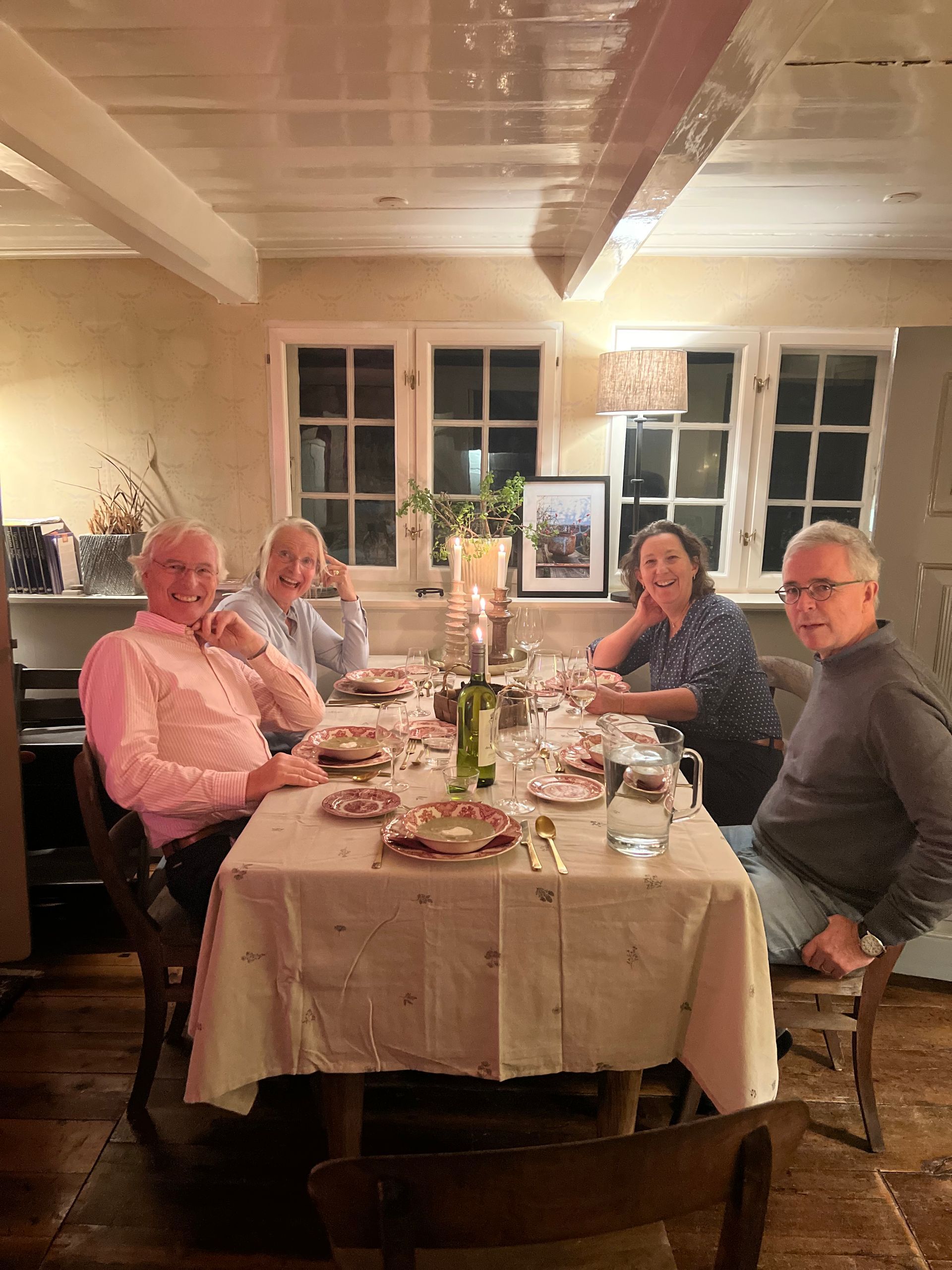 A group of people are sitting at a table with plates of food.