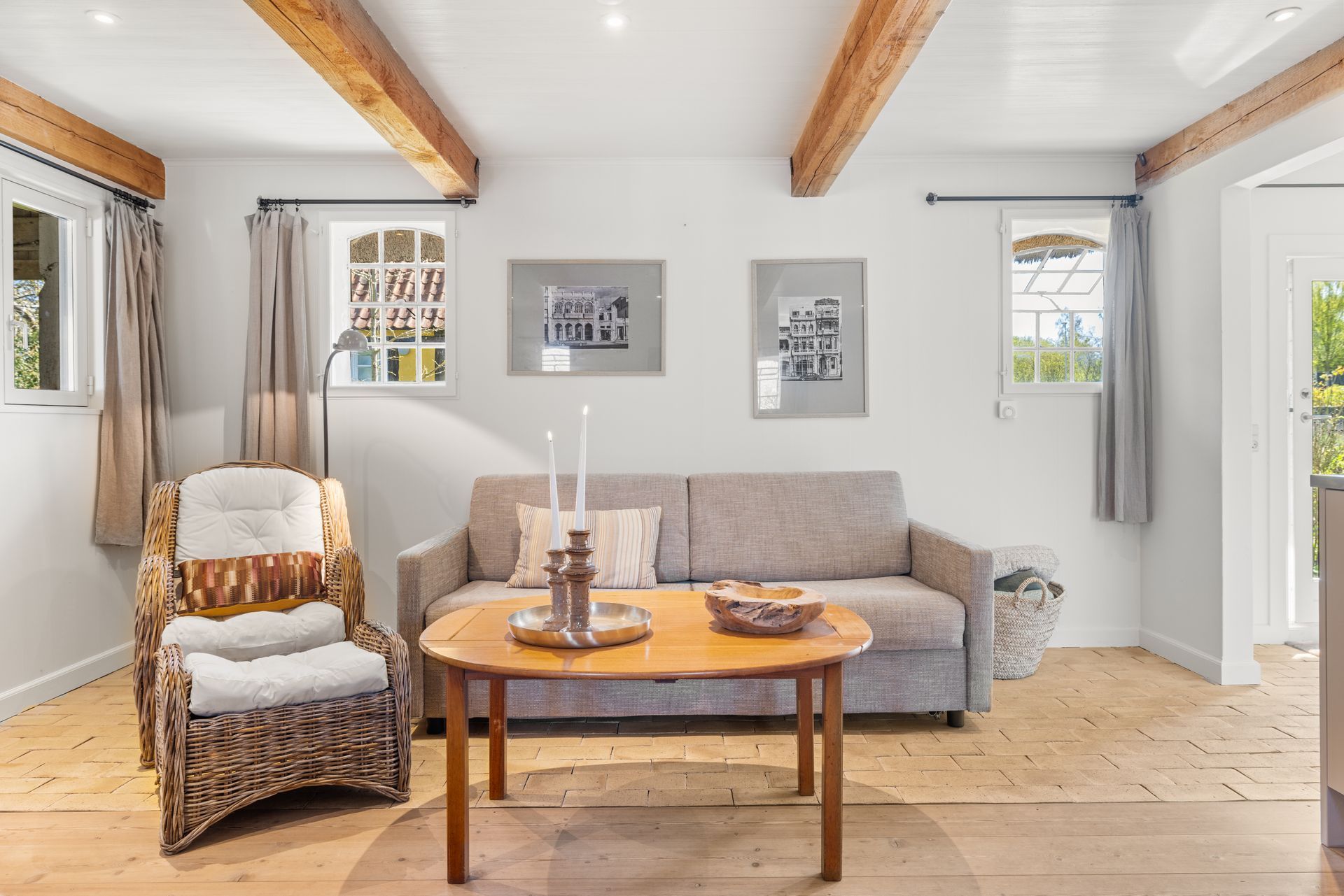 A living room with a couch , table and chairs