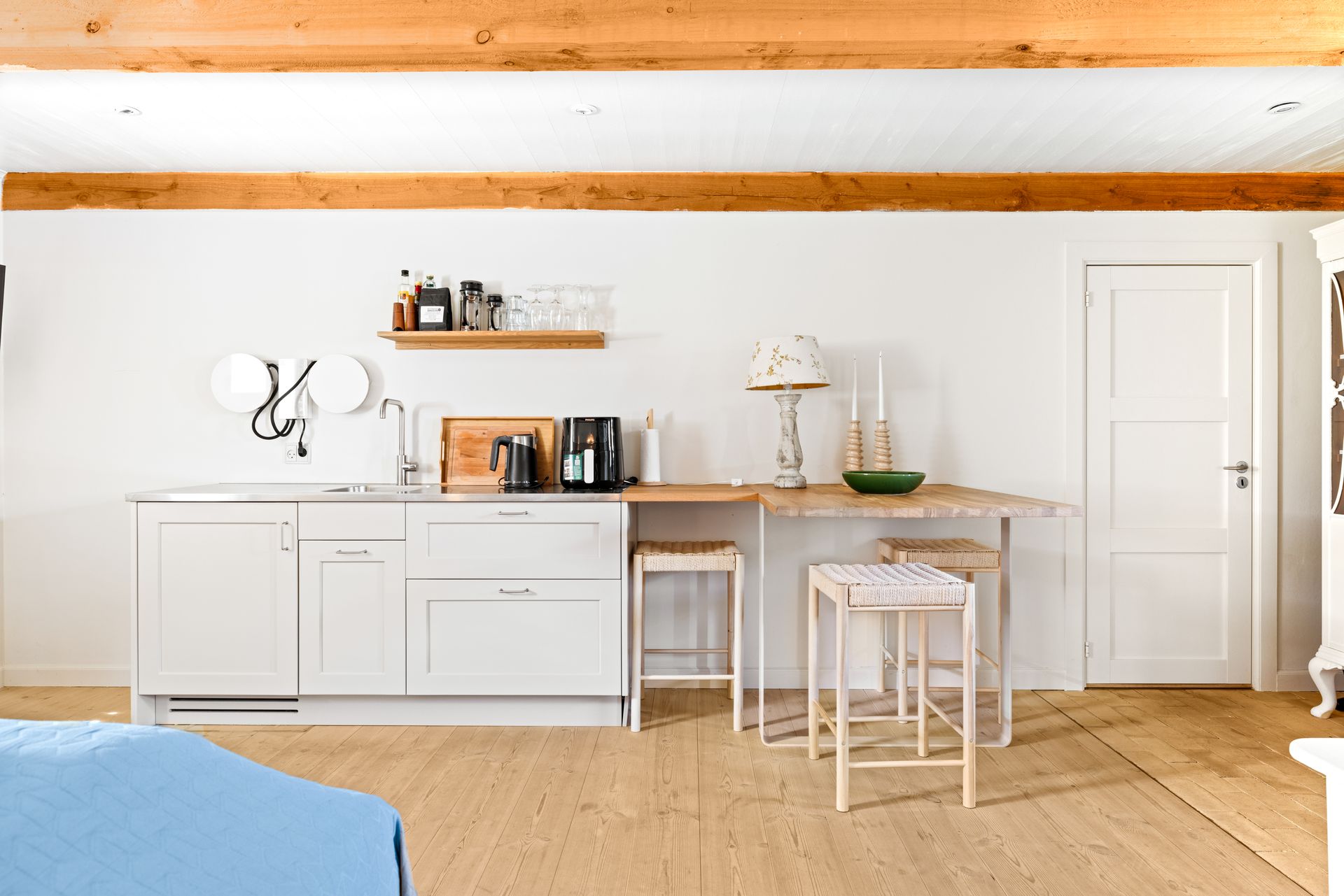 A kitchen with white cabinets and a wooden table