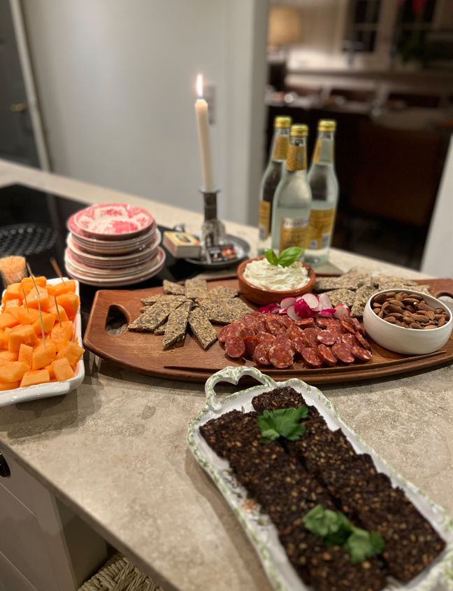 A table topped with plates of food and bottles of water.