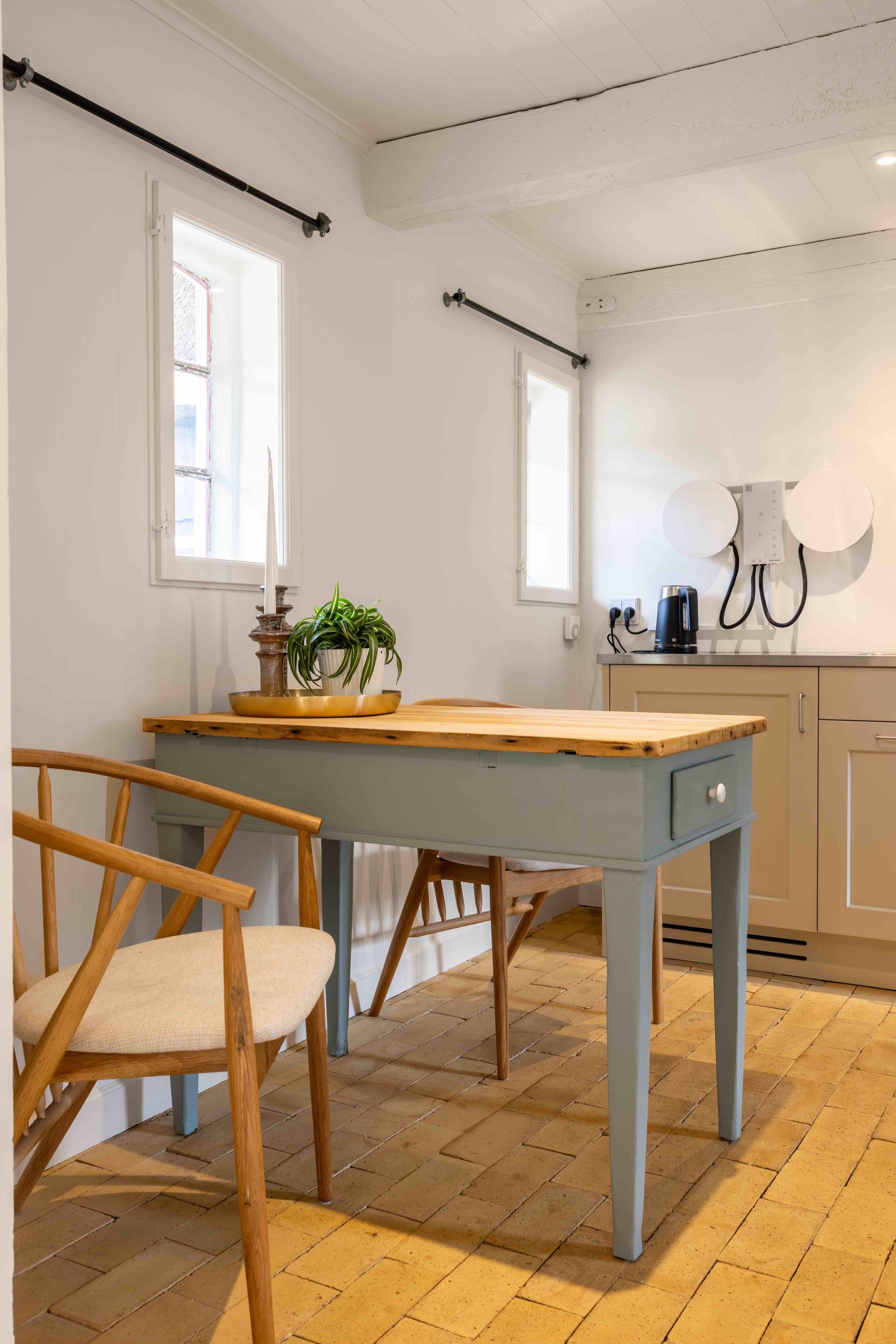 There is a table and chairs in the room.