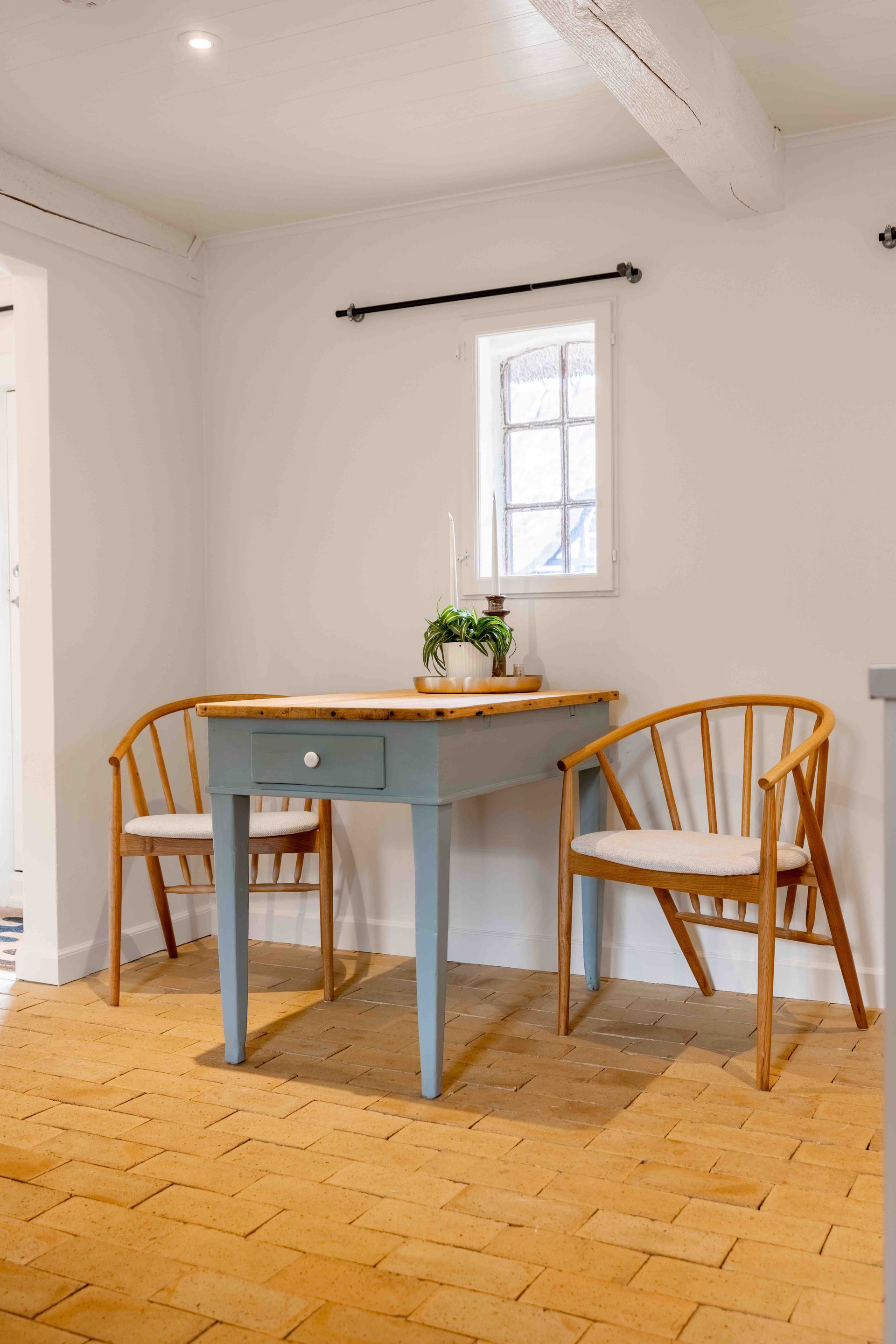 There is a table and two chairs in the room.