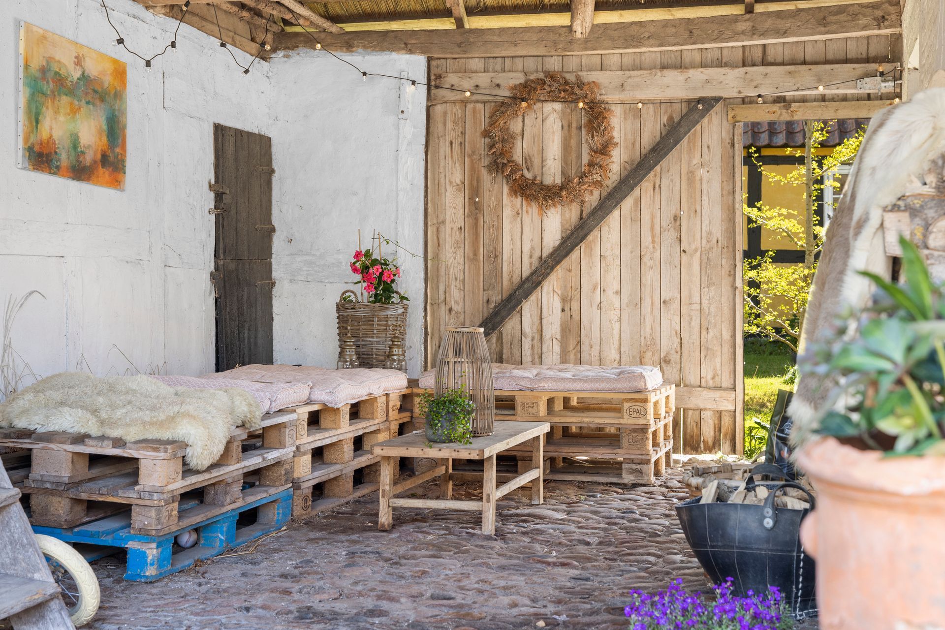 A patio with wooden pallets and a table.