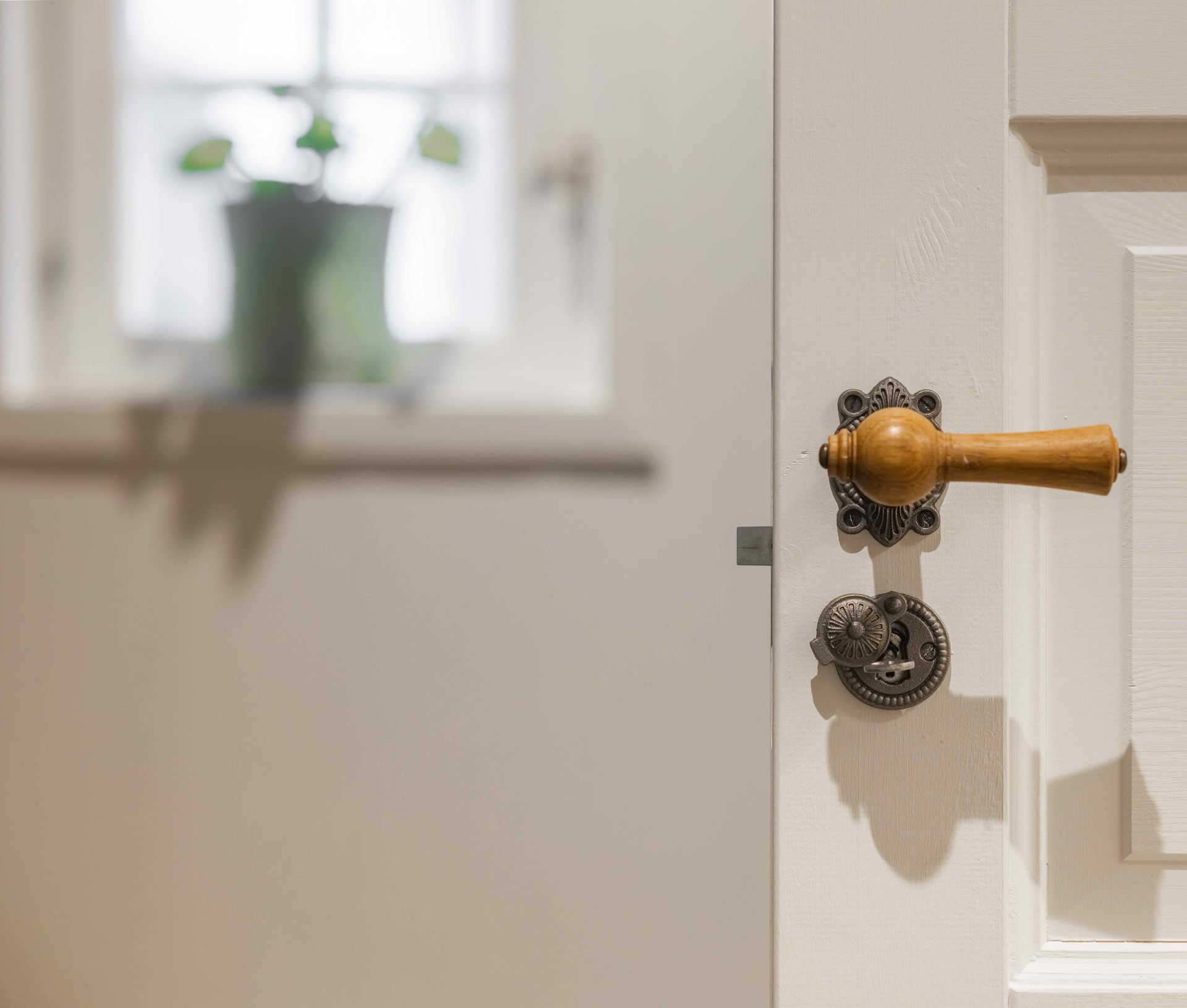 Renovated B&B farmhouse with restored timber beams, fresh white walls and lush green surroundings