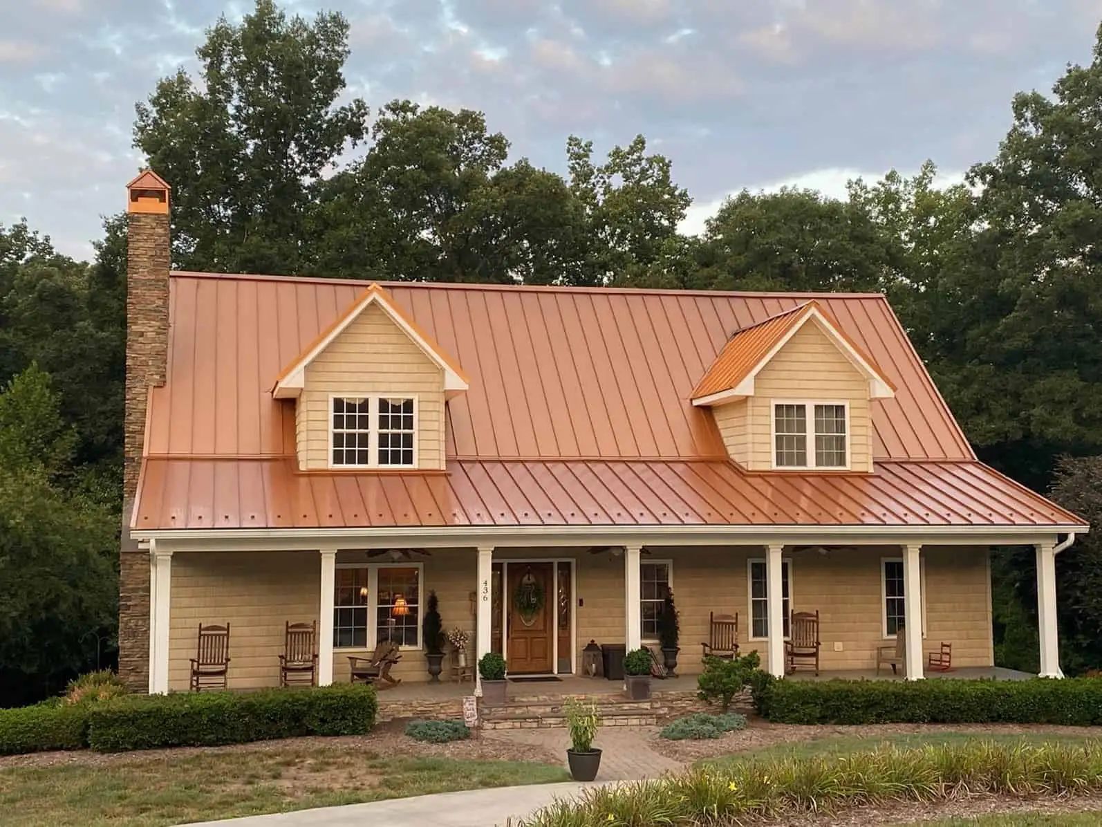 A large brick house with a metal roof