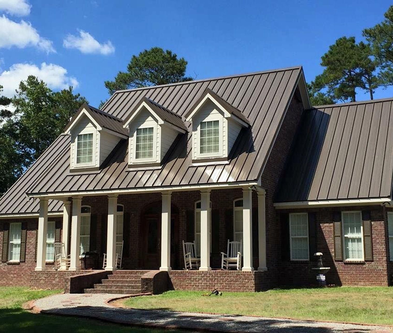 A large brick house with a metal roof