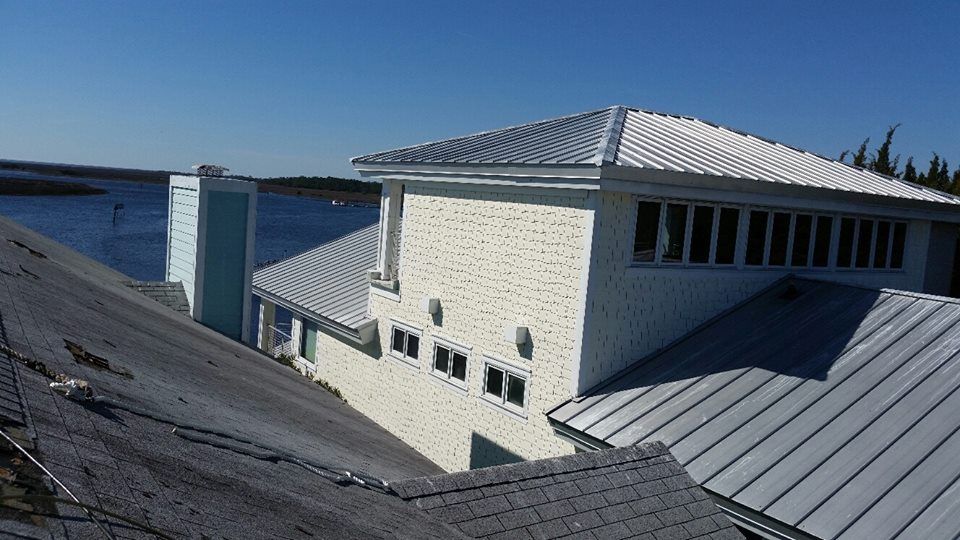 A large brick house with a metal roof