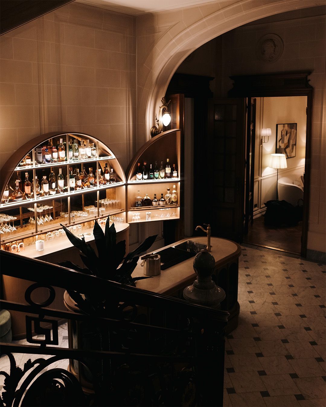 Three friends laughing and dancing in a dimly lit setting; one wears a sequined dress.