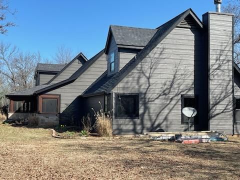 Side view of house with siding and paint
