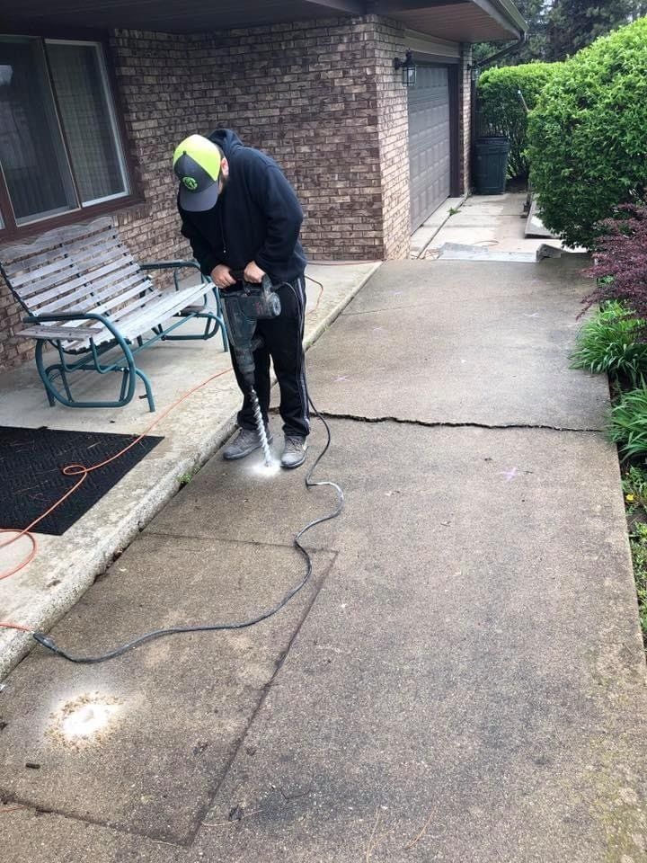 Worker Repairing Cracks in Patio — Rockford, IL — Northern Illinois Concrete Lifting