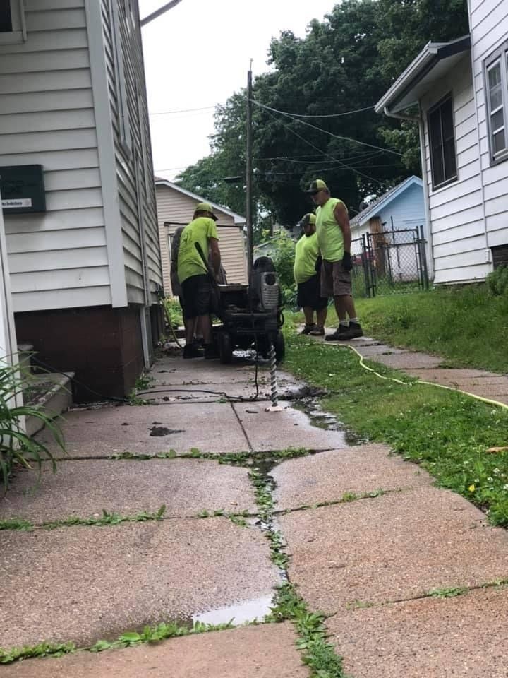 Workers Repairing the Unleveled Sidewalk — Rockford, IL — Northern Illinois Concrete Lifting