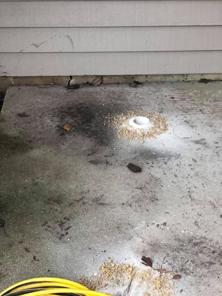 Grout Mixture on Concrete Floor and Yellow Hose — Rockford, IL — Northern Illinois Concrete Lifting