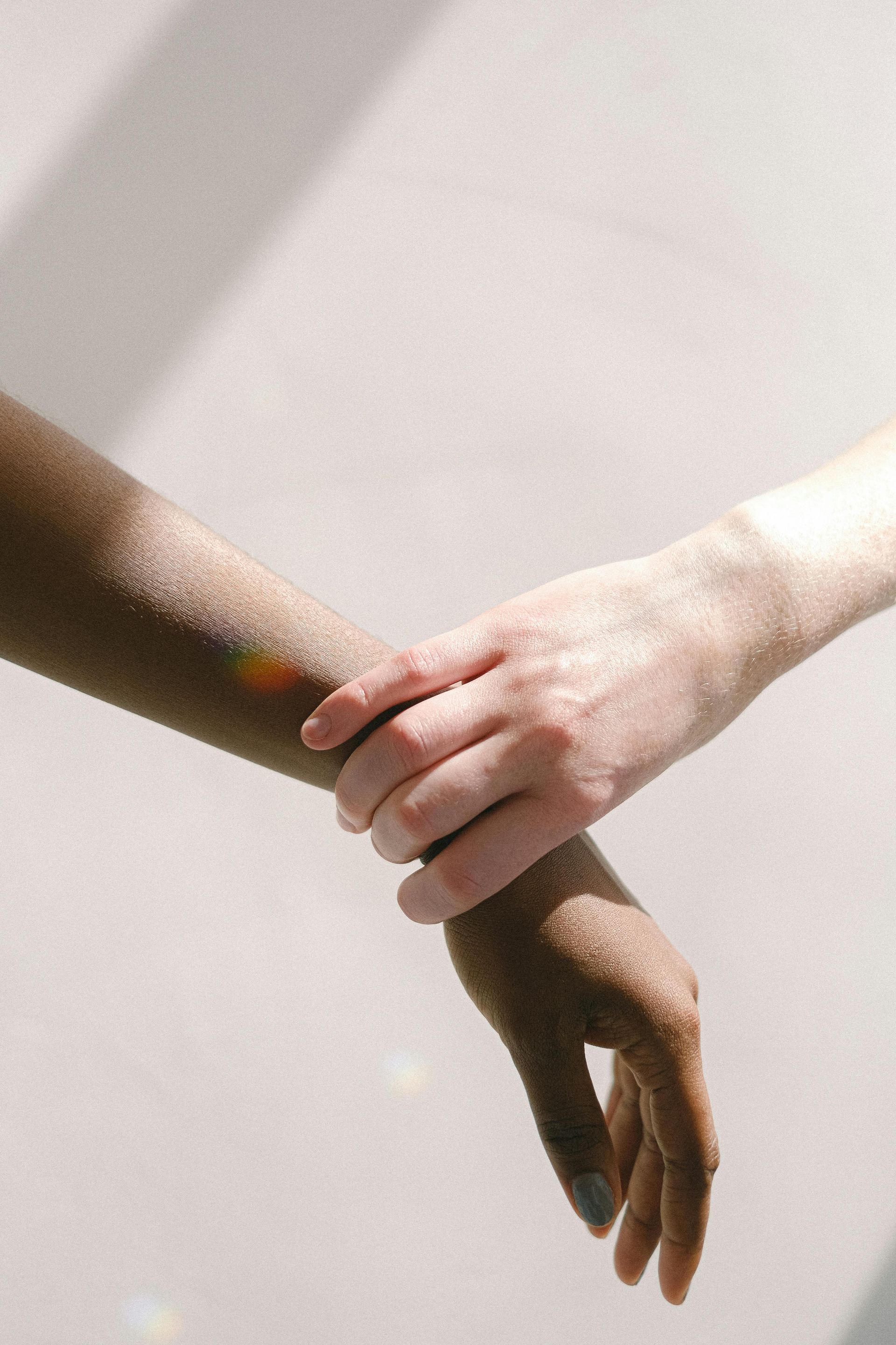 A close up of a person holding another person 's arm.