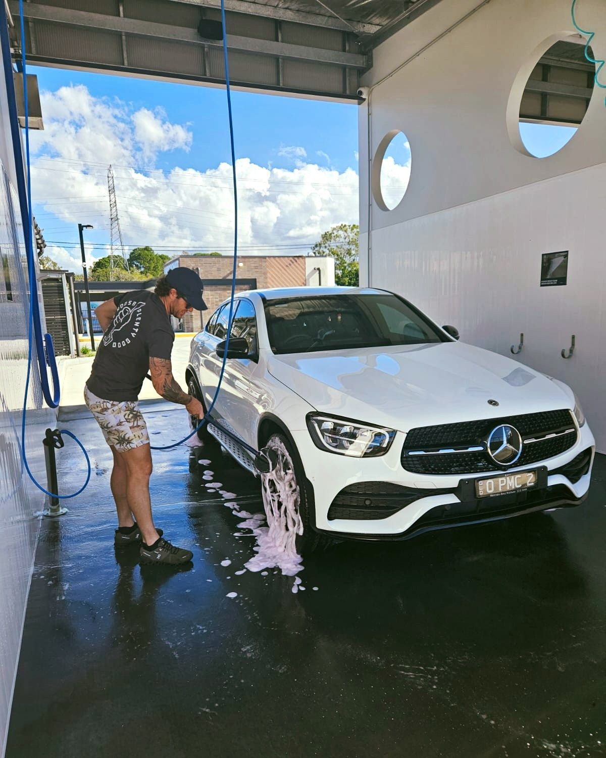 A Man Is Washing A White Mercedes Benz At A Car Wash — Carwash 44 In Caboolture, QLD