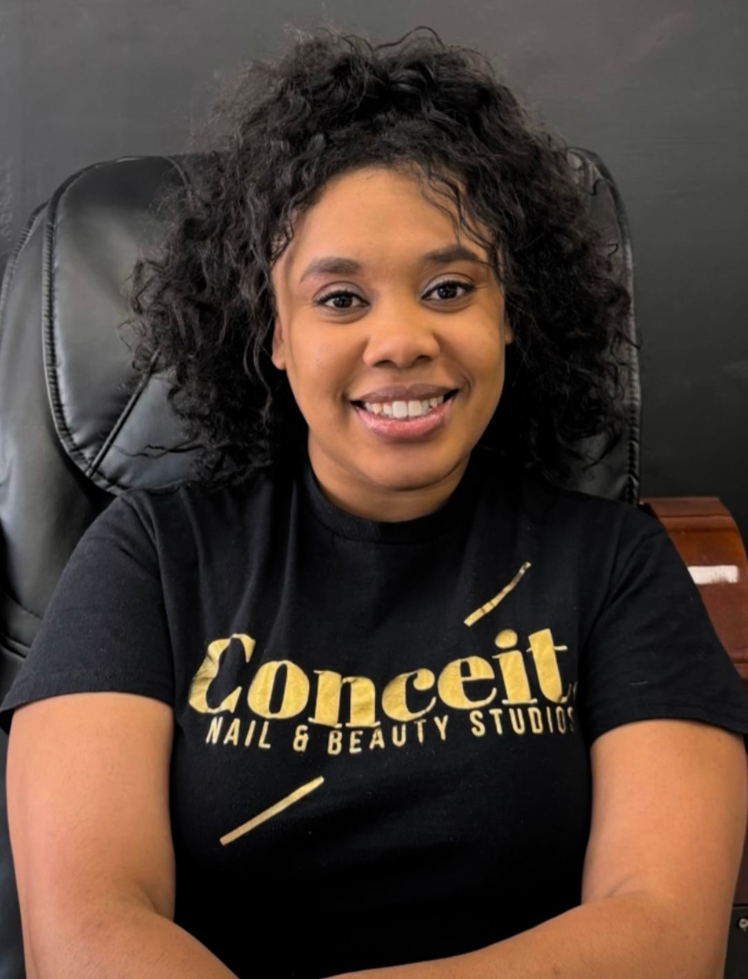 Logo for Conceit. Nail & Beauty Studios; black text on a yellow background, with black diagonal lines.