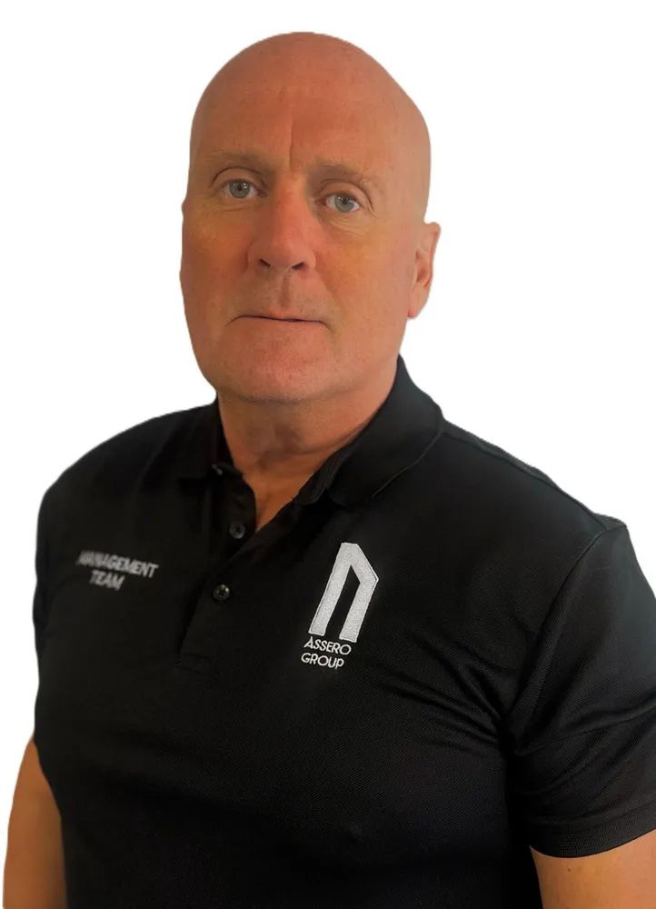 A professional headshot of a person wearing a black polo shirt with an