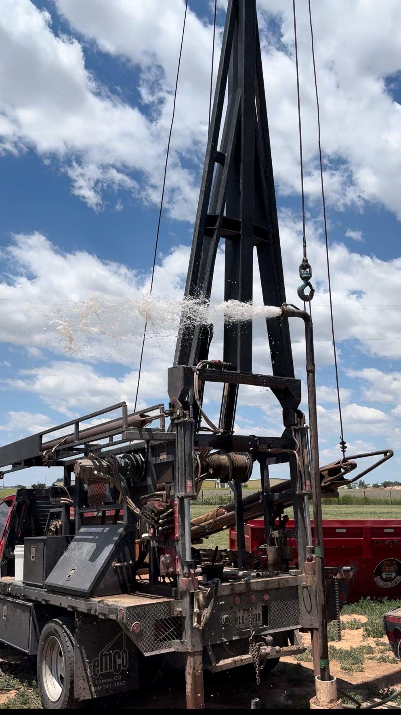 A large pile of dirt is sitting in a field next to a truck — Seminole, TX — Shpuetz Drilling