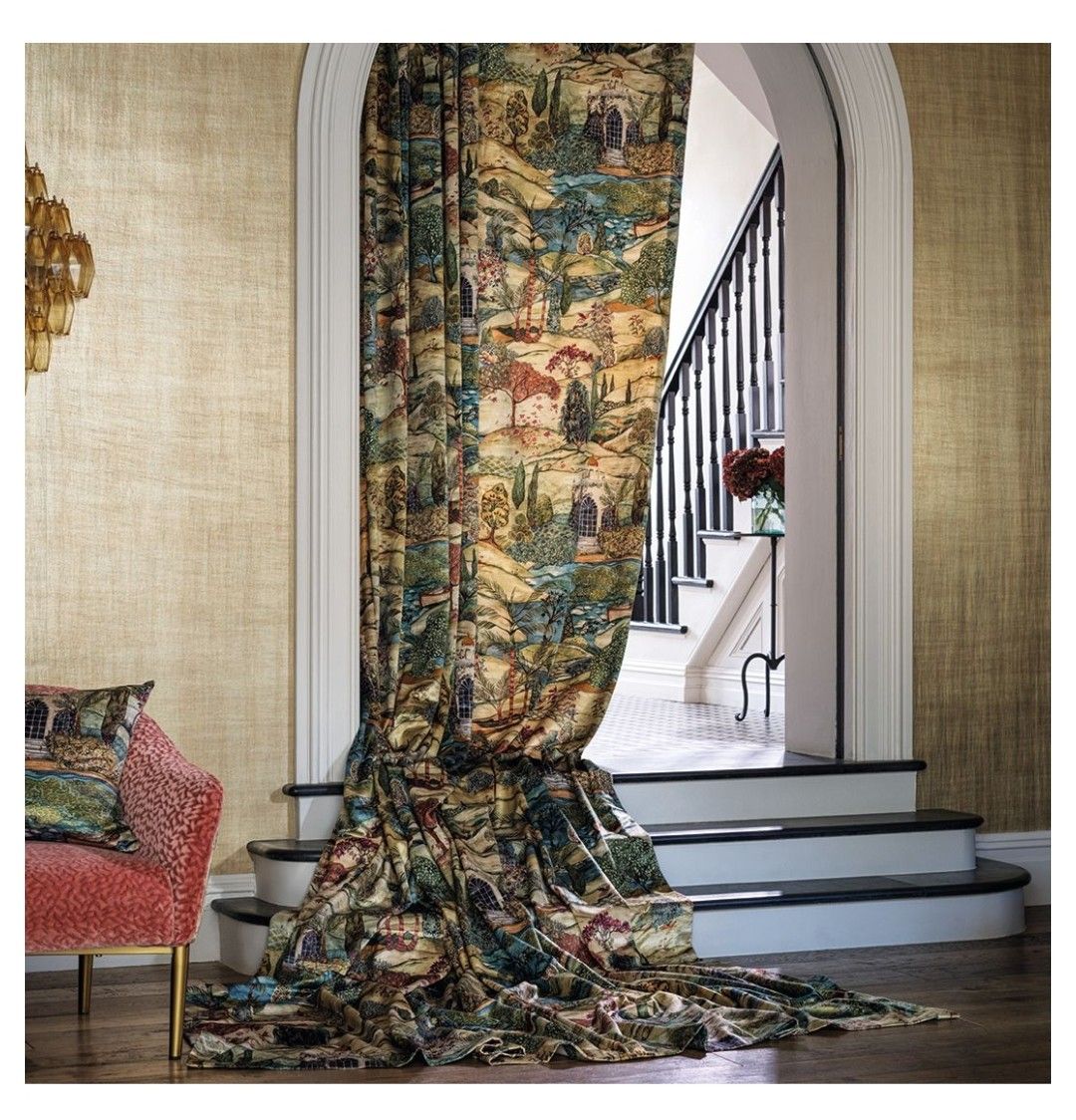 Una tenda con motivo paesaggistico è appesa all'ingresso, accanto a una scala. Le pareti sono decorate con texture color oro.