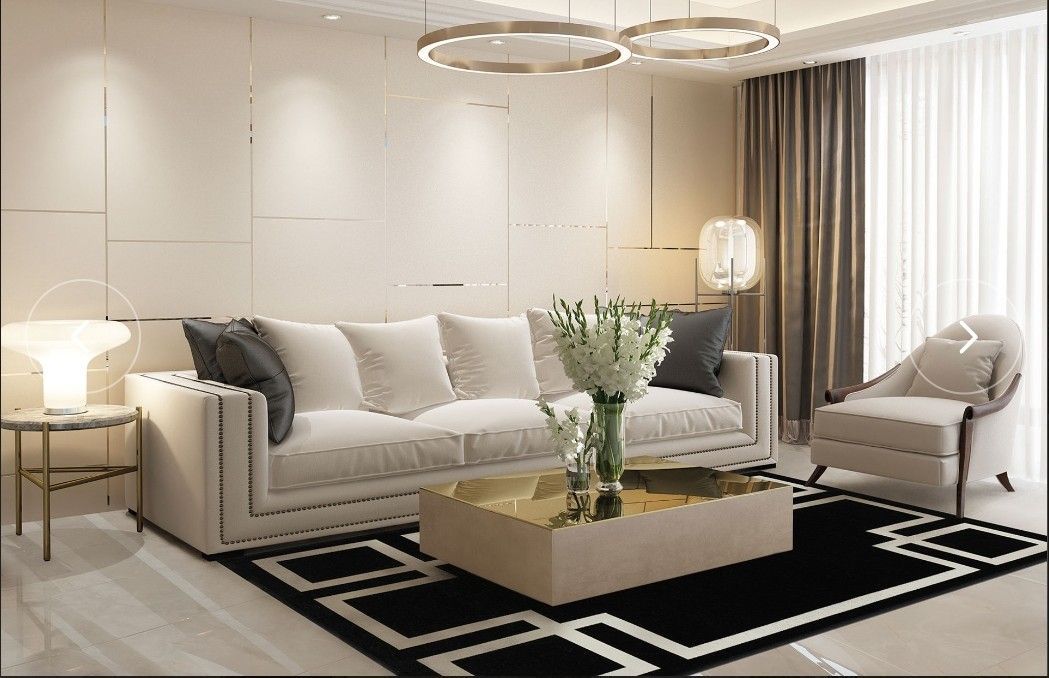 Soggiorno con divano beige, tavolino da caffè dorato e tappeto bianco e nero.