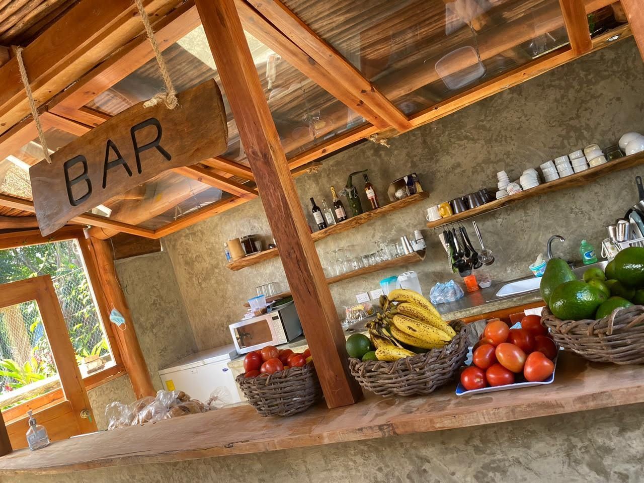 Bar with wooden frame, fruit baskets, and bar supplies.