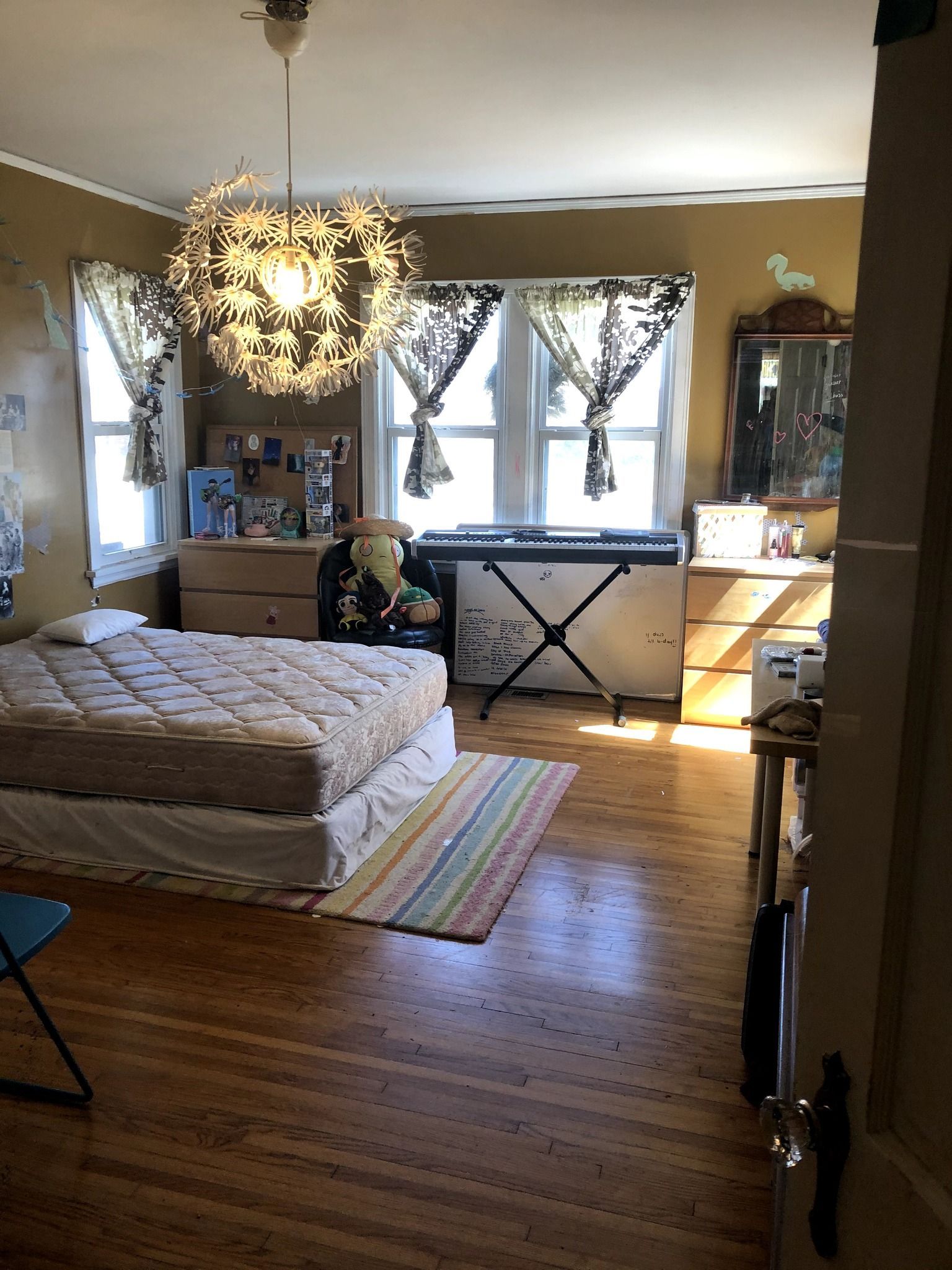 A bedroom with a bed and a piano in it