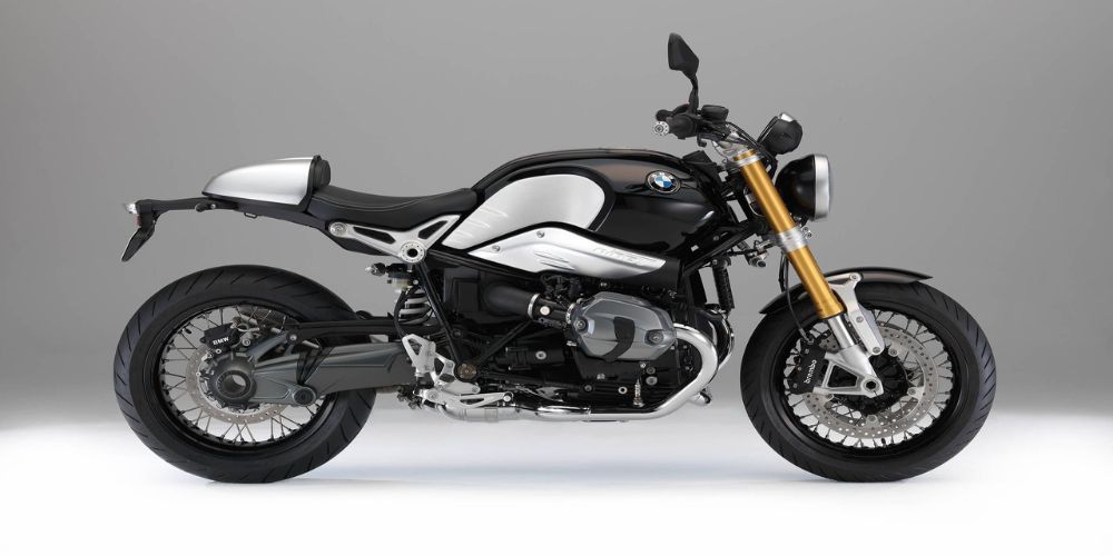 A 2015 BMW R Nine T  black and white motorcycle is sitting on a white surface.