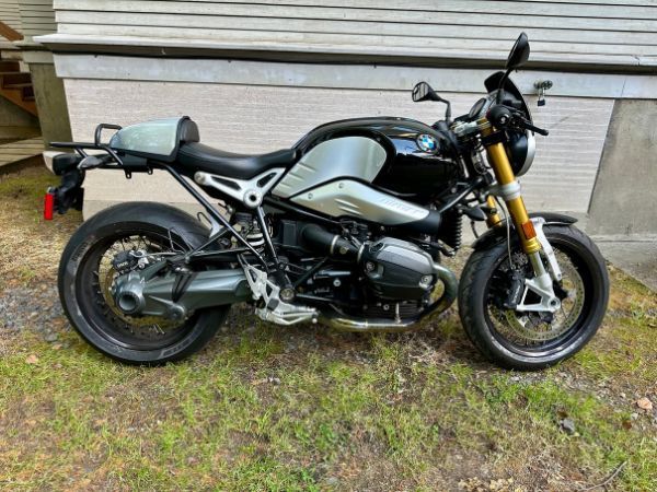 A black motorcycle is parked in front of a building.