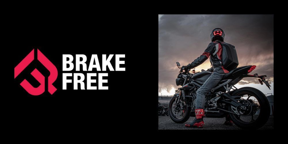 A man is riding a motorcycle next to a brake free logo.