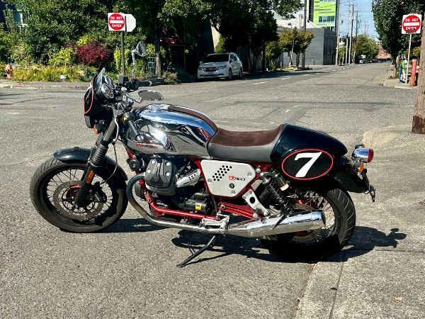 A motorcycle with the number 7 on the side is parked on the side of the road.