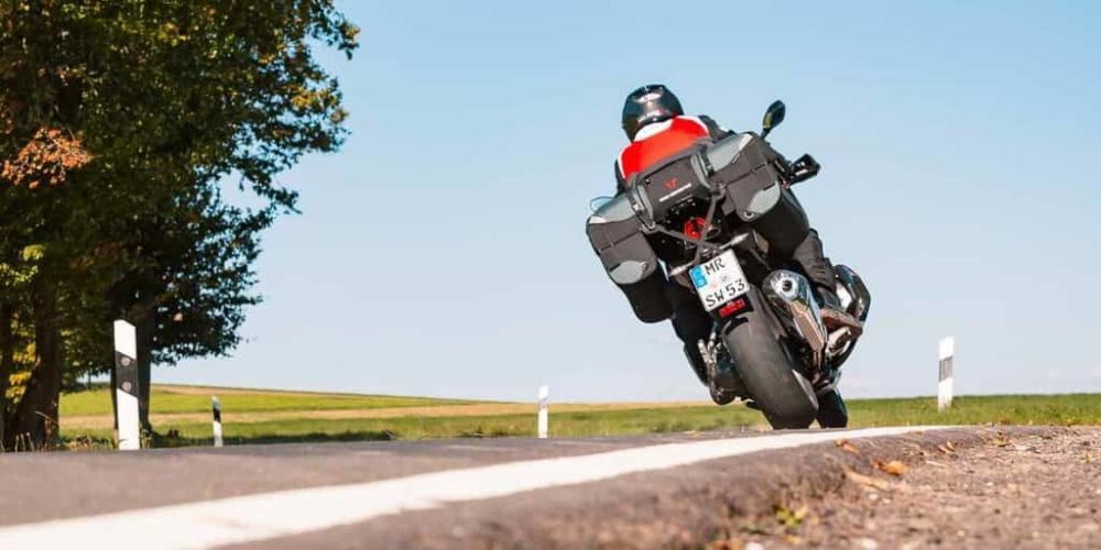 A person is riding a motorcycle down a road.